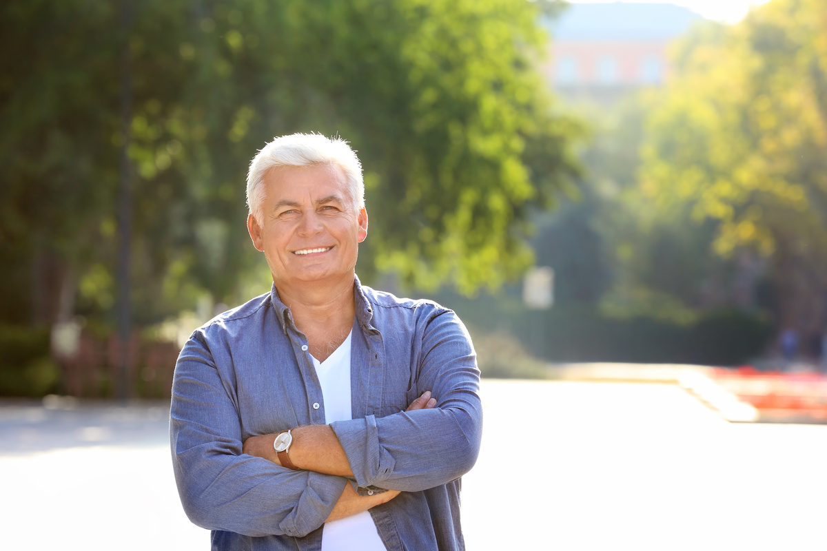 Middle-aged man sitting peacefully outdoors, symbolizing stability while living with schizophrenia as he ages.