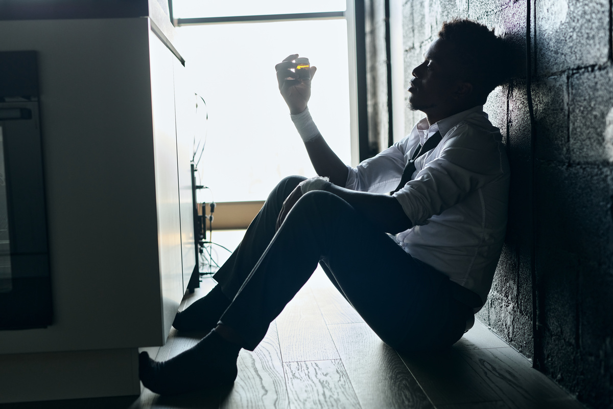 Young man sitting alone, appearing thoughtful and concerned about mental health